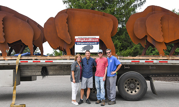 Family In Front Of Metal Bisons