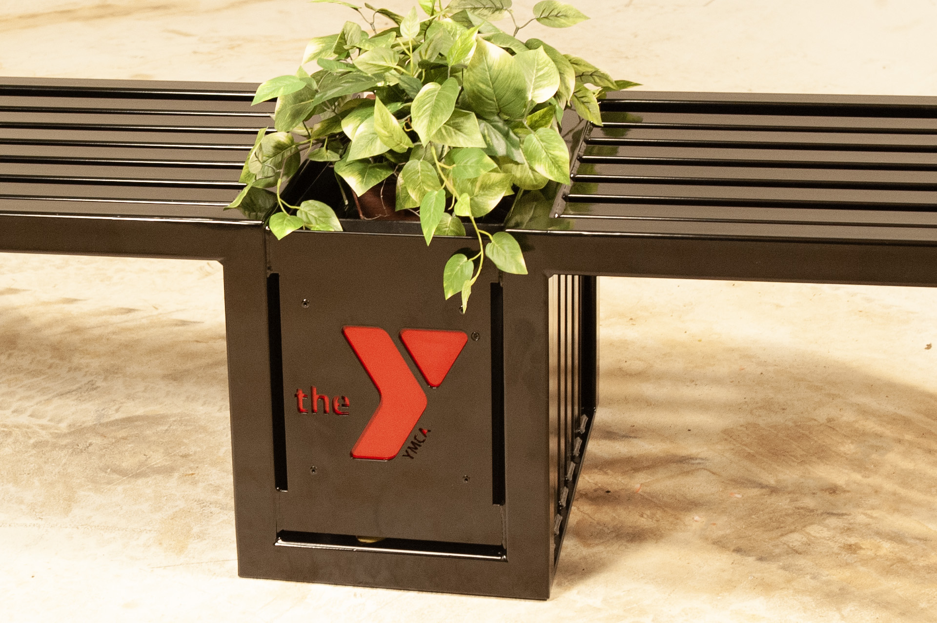 Plaza Bench With Planter 6Ft Lasercut Bronze Logo Closeup